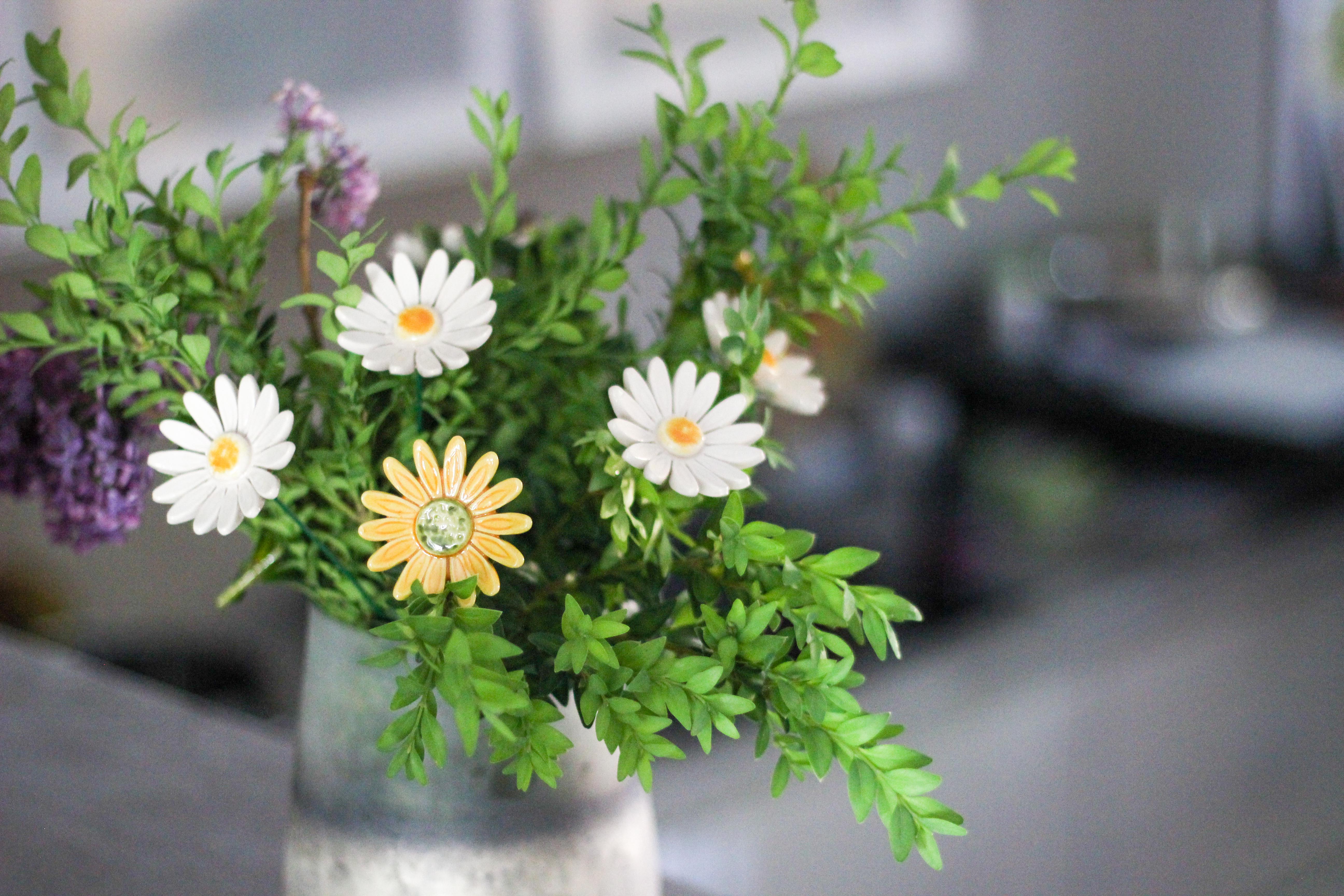 ceramic daisy in a daisy plant