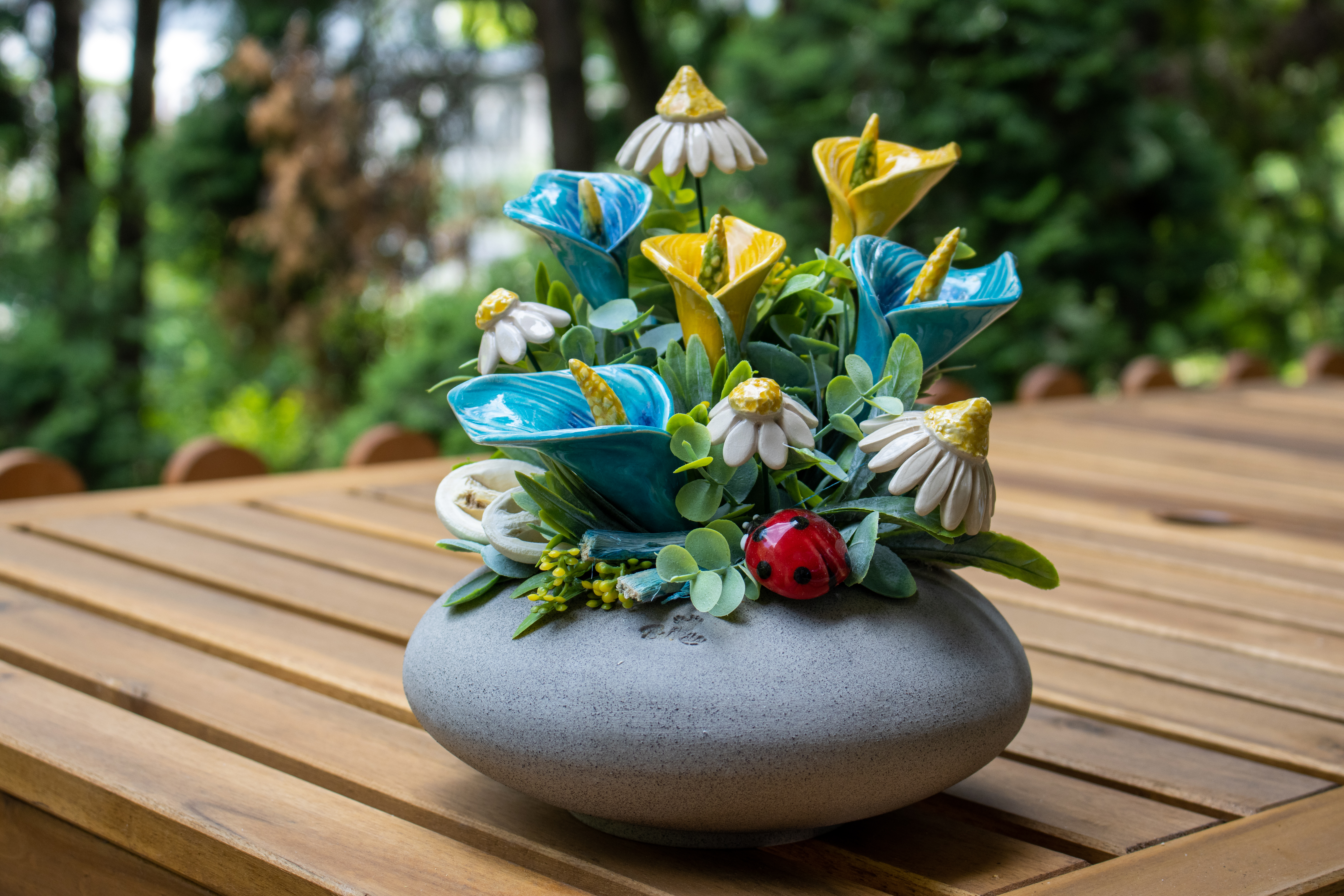 ceramic flower table decoration on the garden table